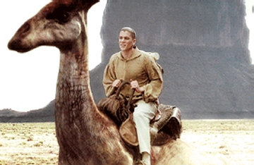 Wentworth Miller as David Scott riding a parasaurolophus dinosaur in Dinotopia